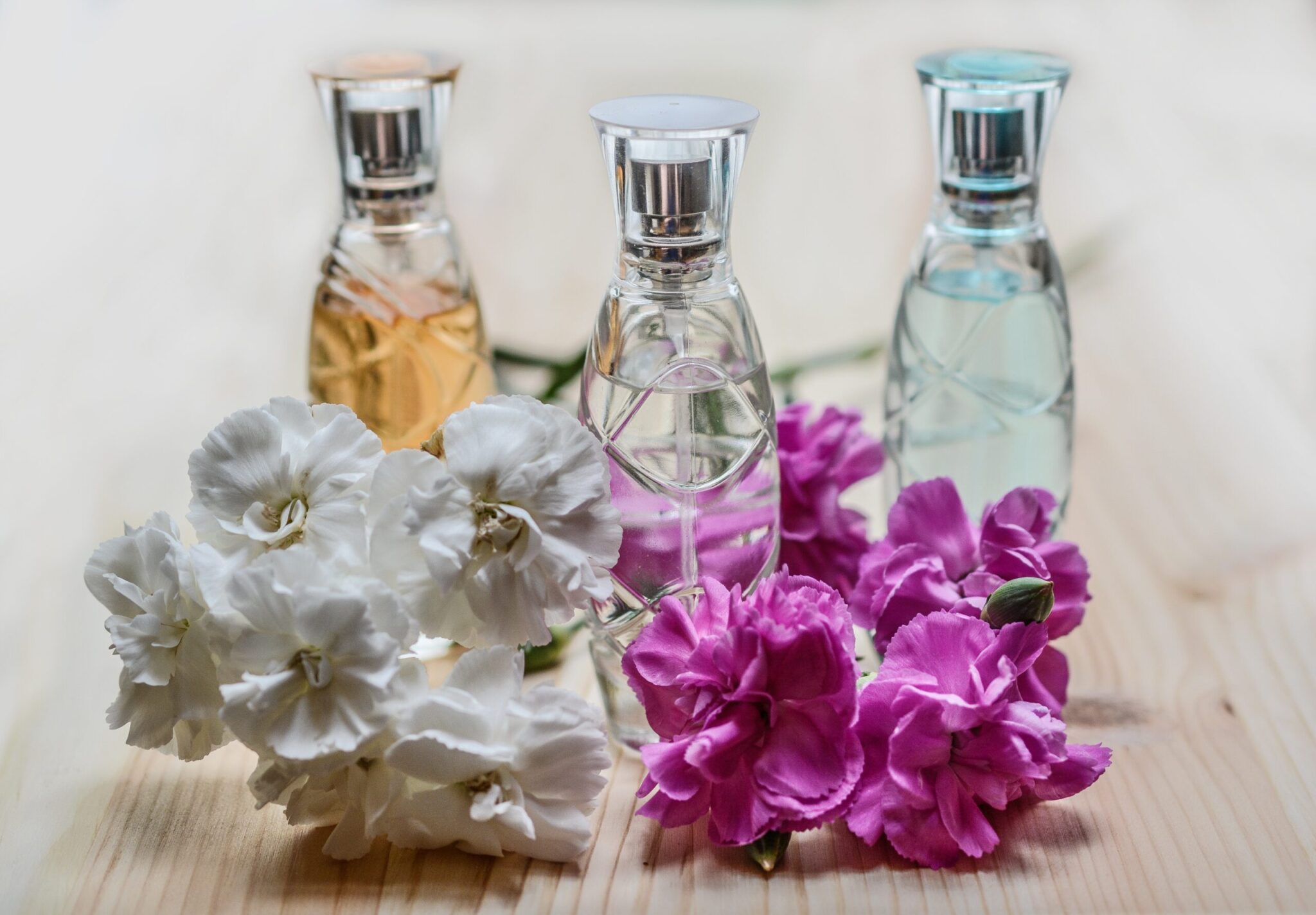 3 bottles of perfume surrounded by the fragence of several flowers to represent the 3 amazing benefits that will come with conscious living